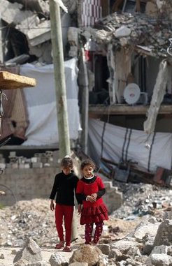 palestinian-girls-walk-past-buildings-in-gaza-thomas-coex-afp-getty