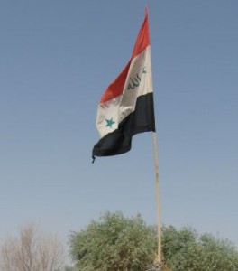 Iraqi flag flying in a village near Ballad. Photo by Tim King Global News Centre