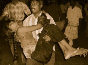 Tamil girl carried by her father, after being attacked by Sri Lanka military in 2009.